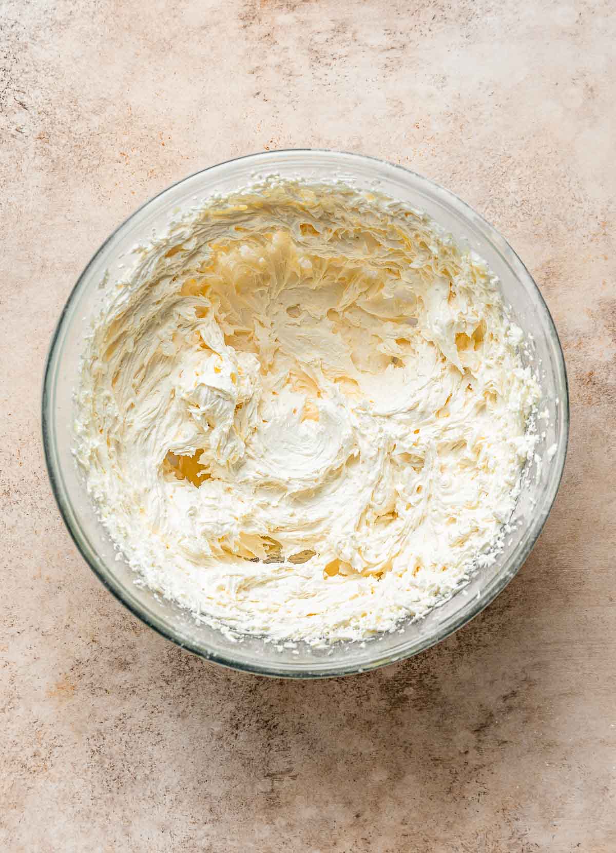 Bowl of whipped vanilla buttercream frosting.