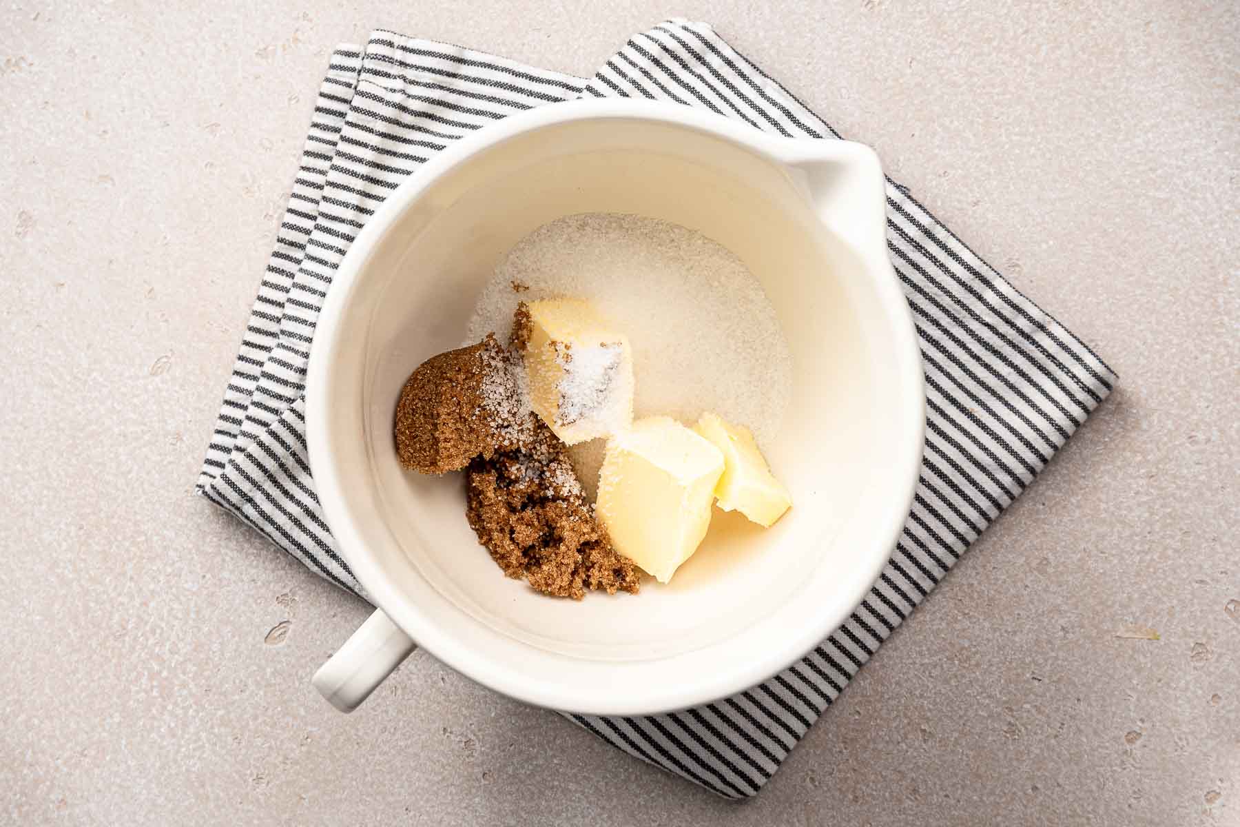 Butter, brown sugar and granulated sugar in mixing bowl.