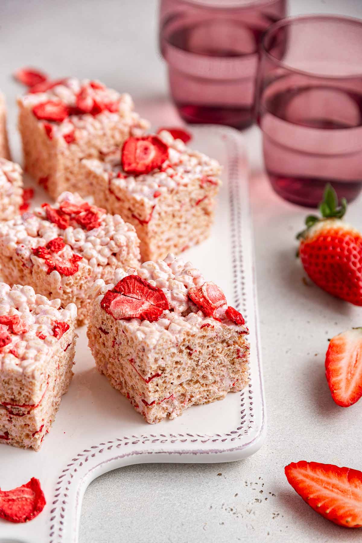 Rice Krispies treats with strawberries on top.