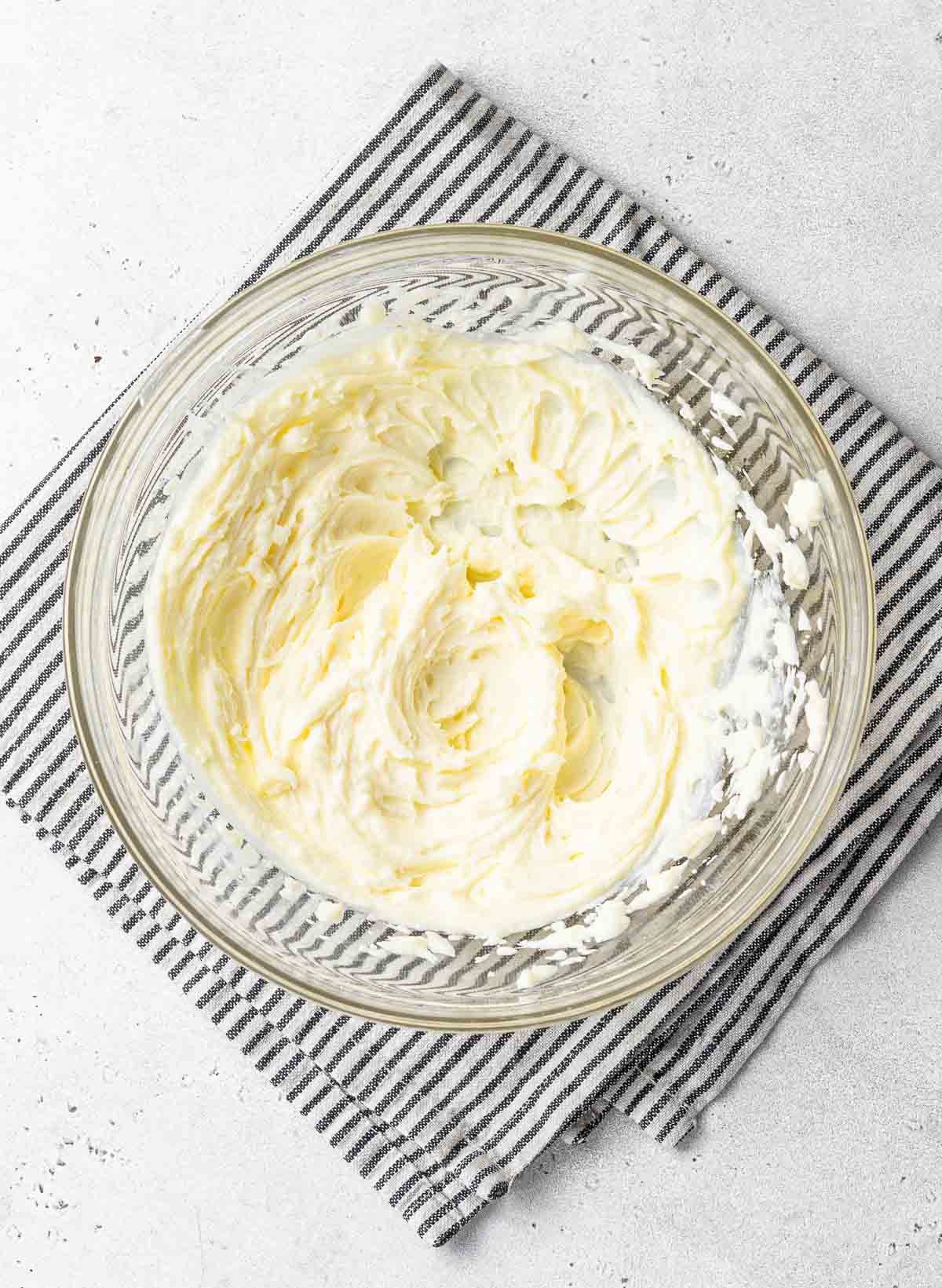 Bowl of whipped lemon cream cheese frosting.