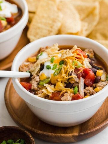 Slow cooker taco soup with tortilla chips and a spoon.