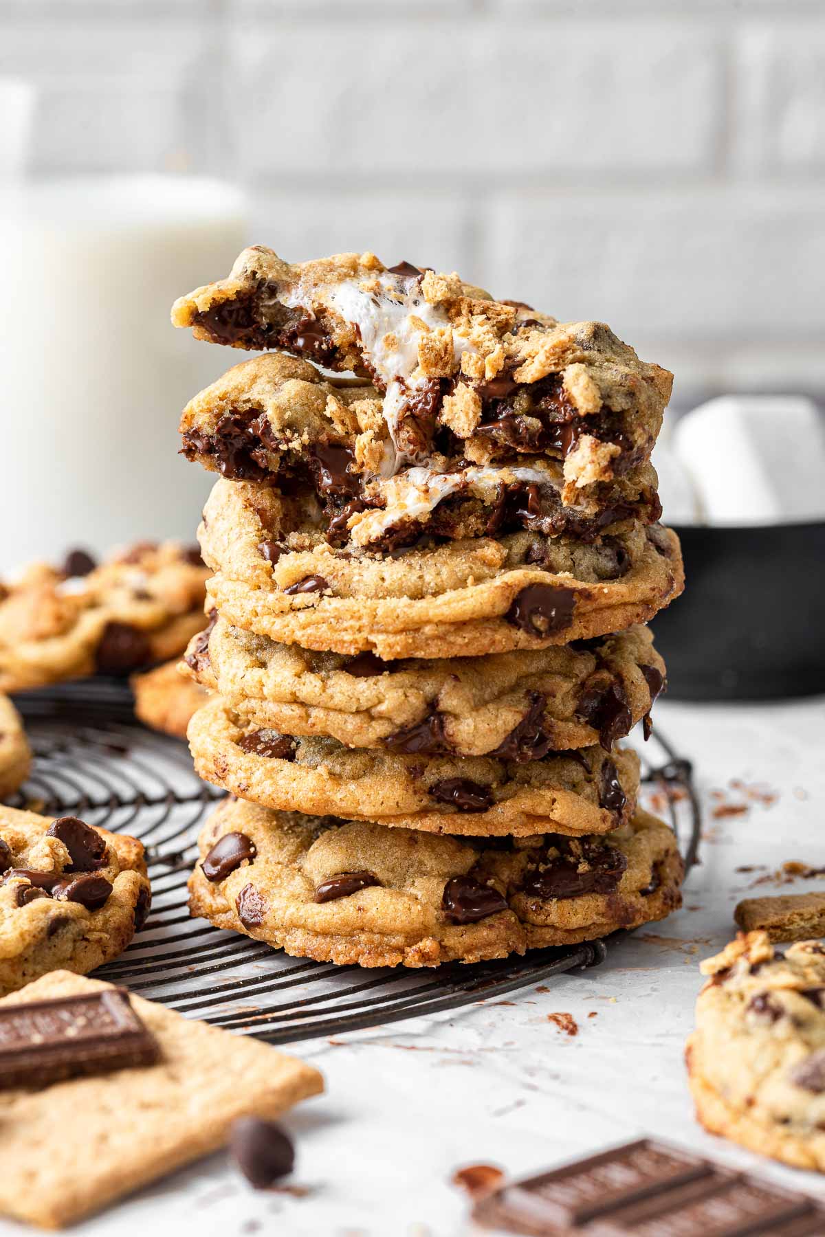 Stack of smores cookies with one split open on top, marshmallow leaking.