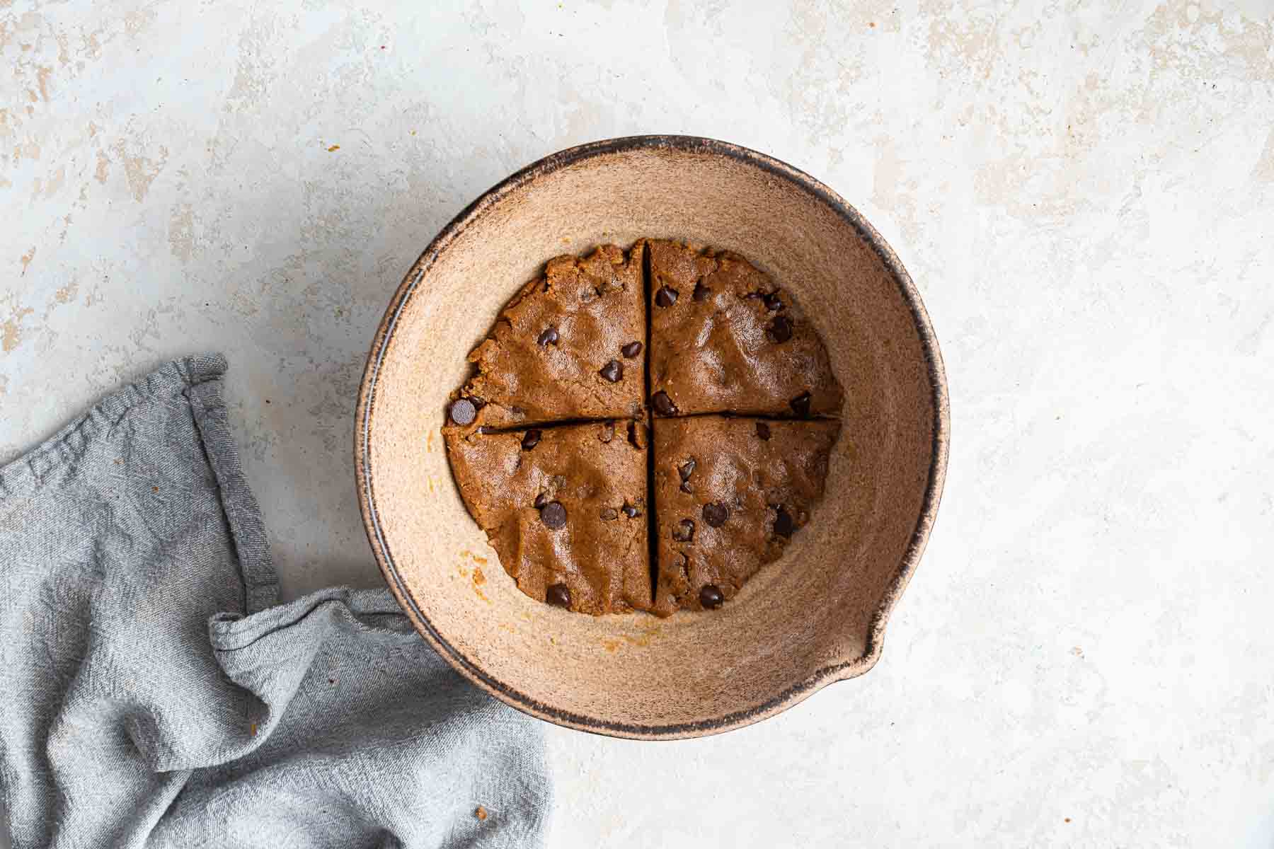 Healthy chocolate chip cookies with coconut oil pressed flat into a bowl.