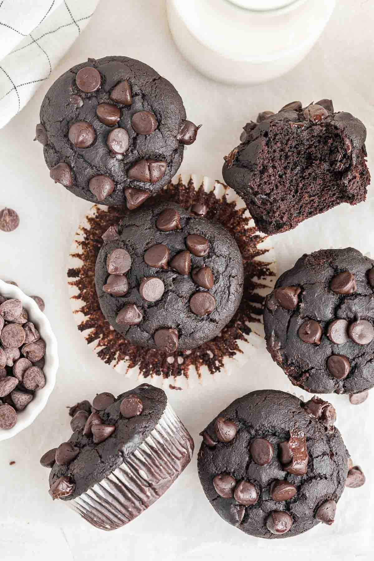 Close up of chocolate pumpkin muffins cut in half to show soft interiors.