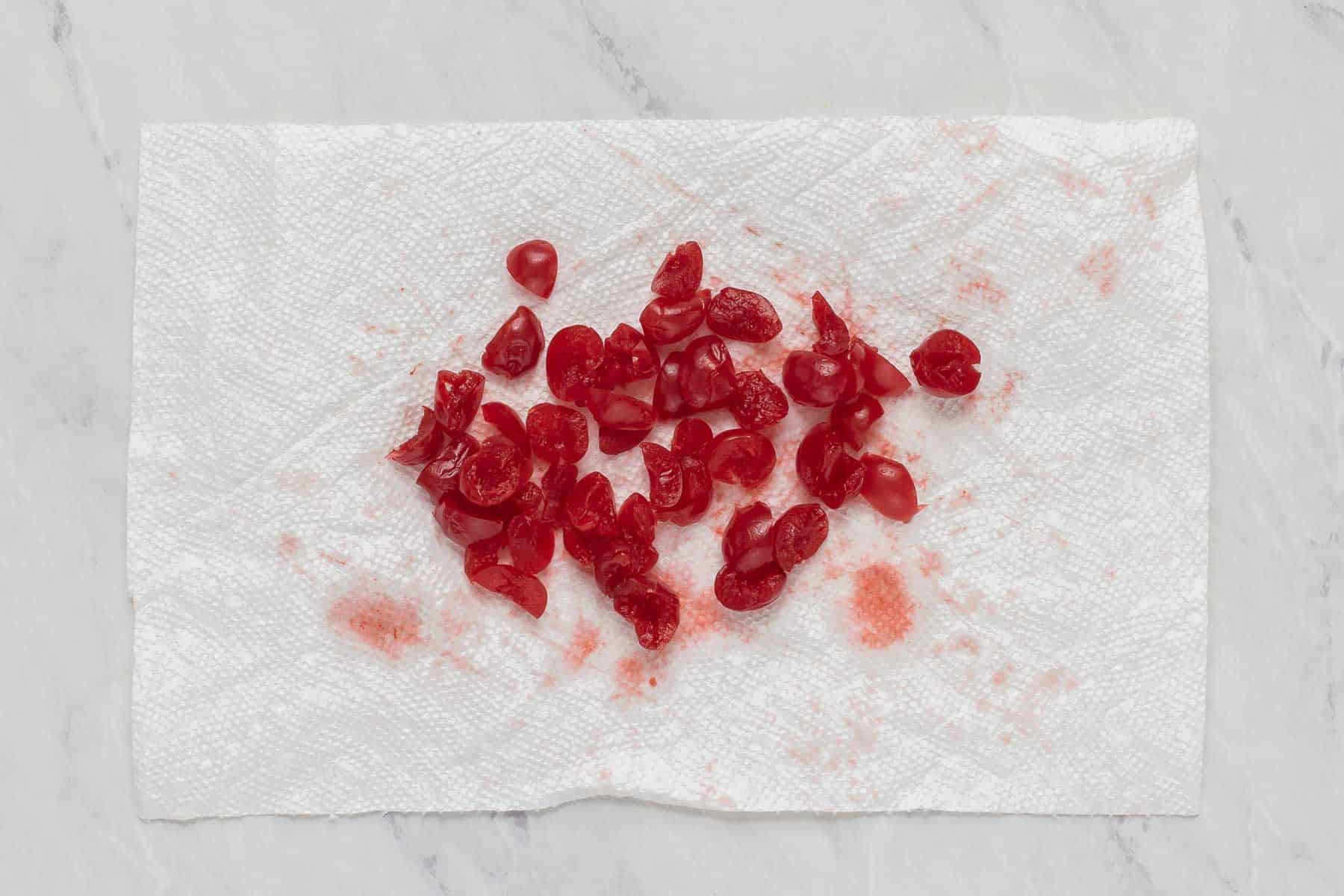 Chopped maraschino cherries on a paper towel.