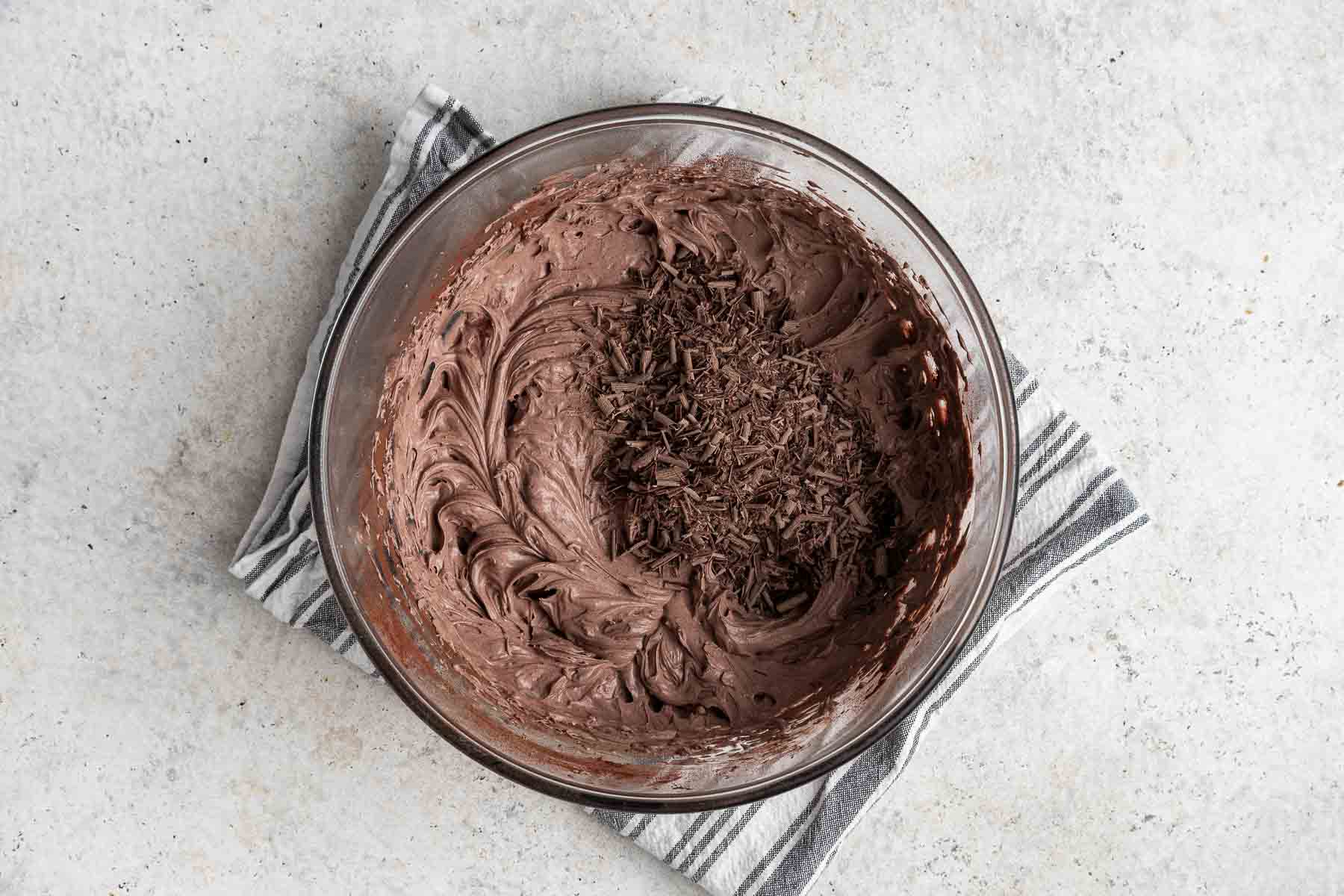 Chocolate shavings on a bowl of whipped cream.