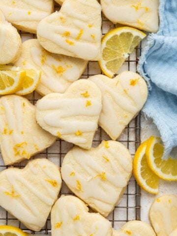Heart lemon shortbread cookies with lemon zest and a blue towel.