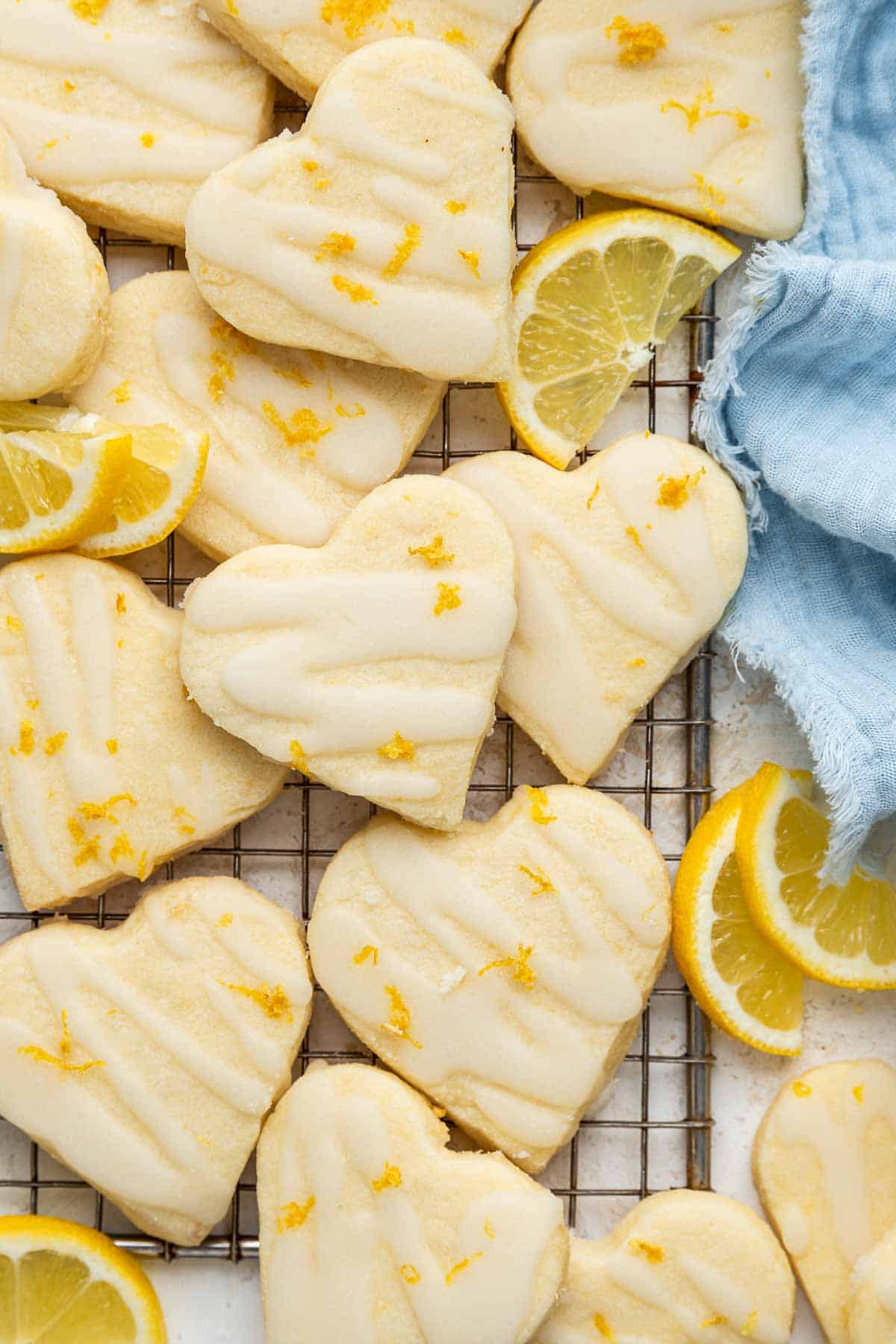 Heart lemon shortbread cookies with lemon zest and a blue towel.