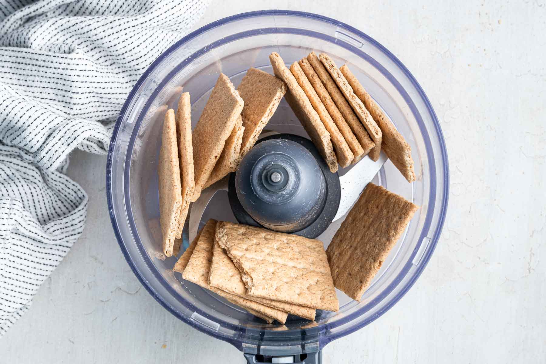 Eight whole graham crackers broken to fit into a food processor bowl.