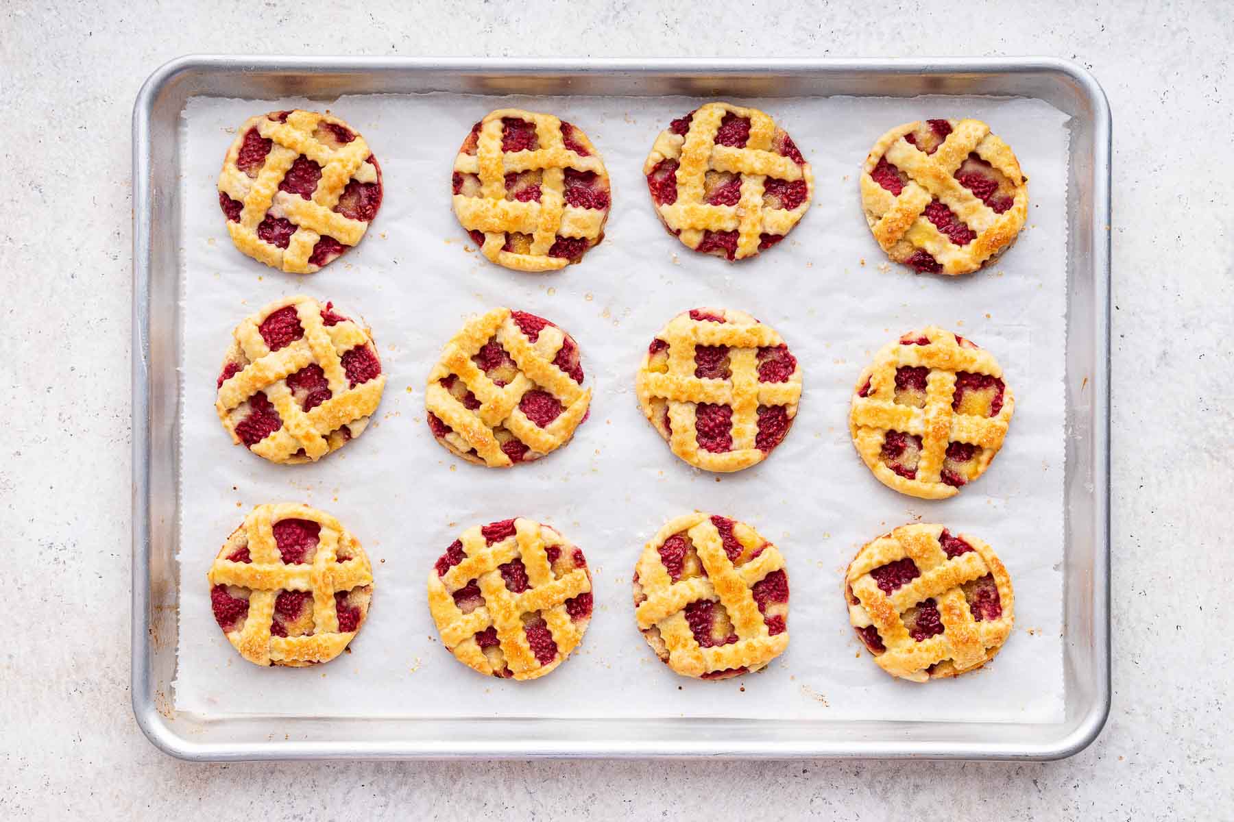 Freshly baked raspberry pie cookies with lattice crust.