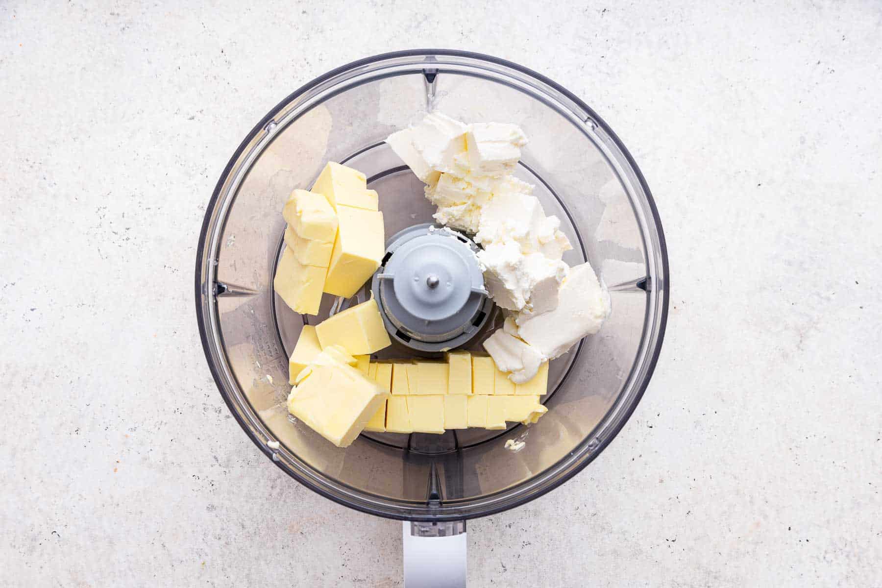 Butter and cream cheese in a food processor.