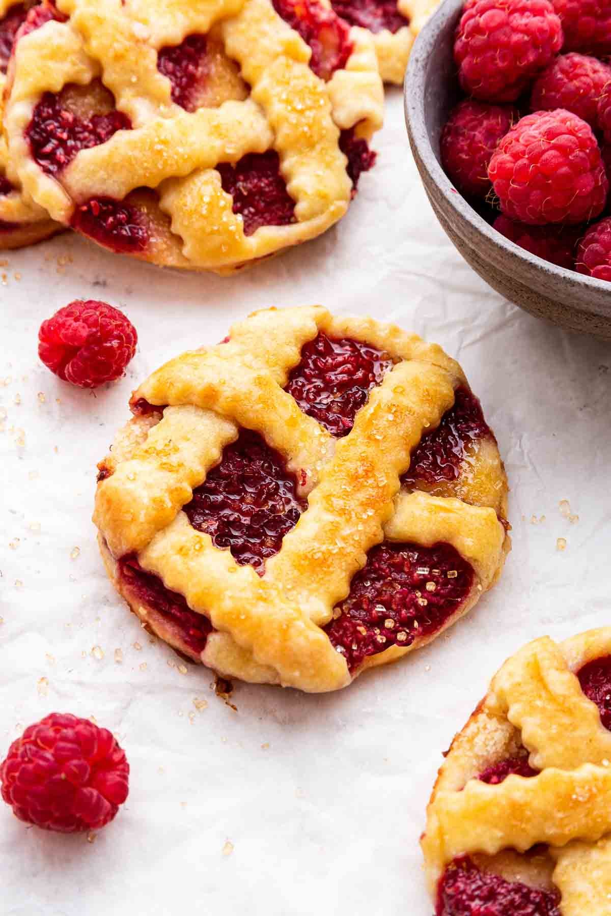 Macro shot of raspberry cookies with lattice pie crust on top.