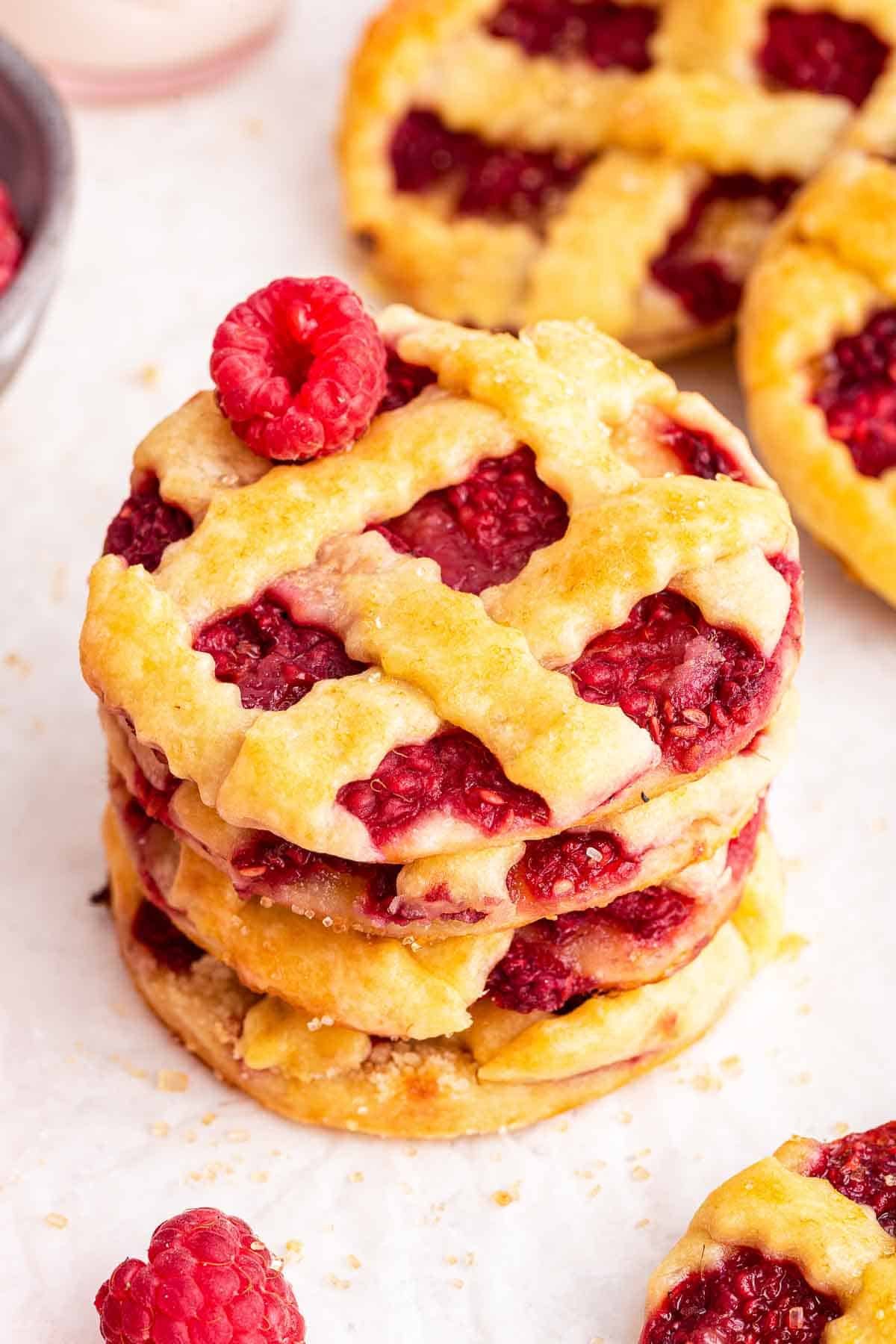 Stack of raspberry lattice pie cookies.