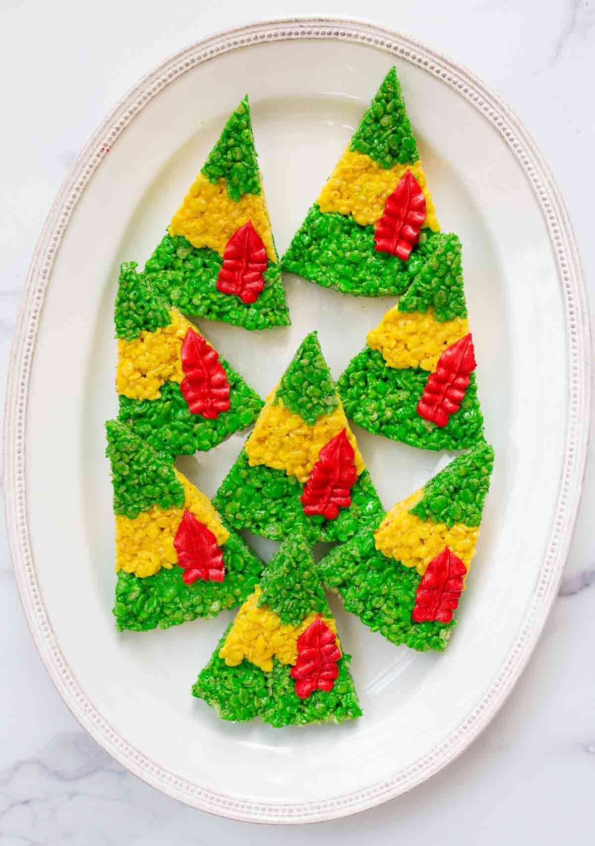 Vertical image of Buddy the Elf Hat Rice Krispies treats on white oval platter.