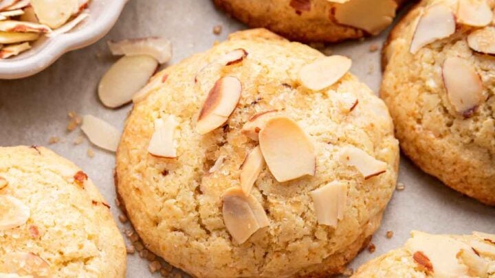 Macro shot of almond croissant cookies with sliced almonds on top.