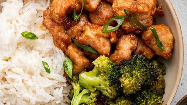 Overhead shot of honey garlic pork in bowl with broccoli and rice.
