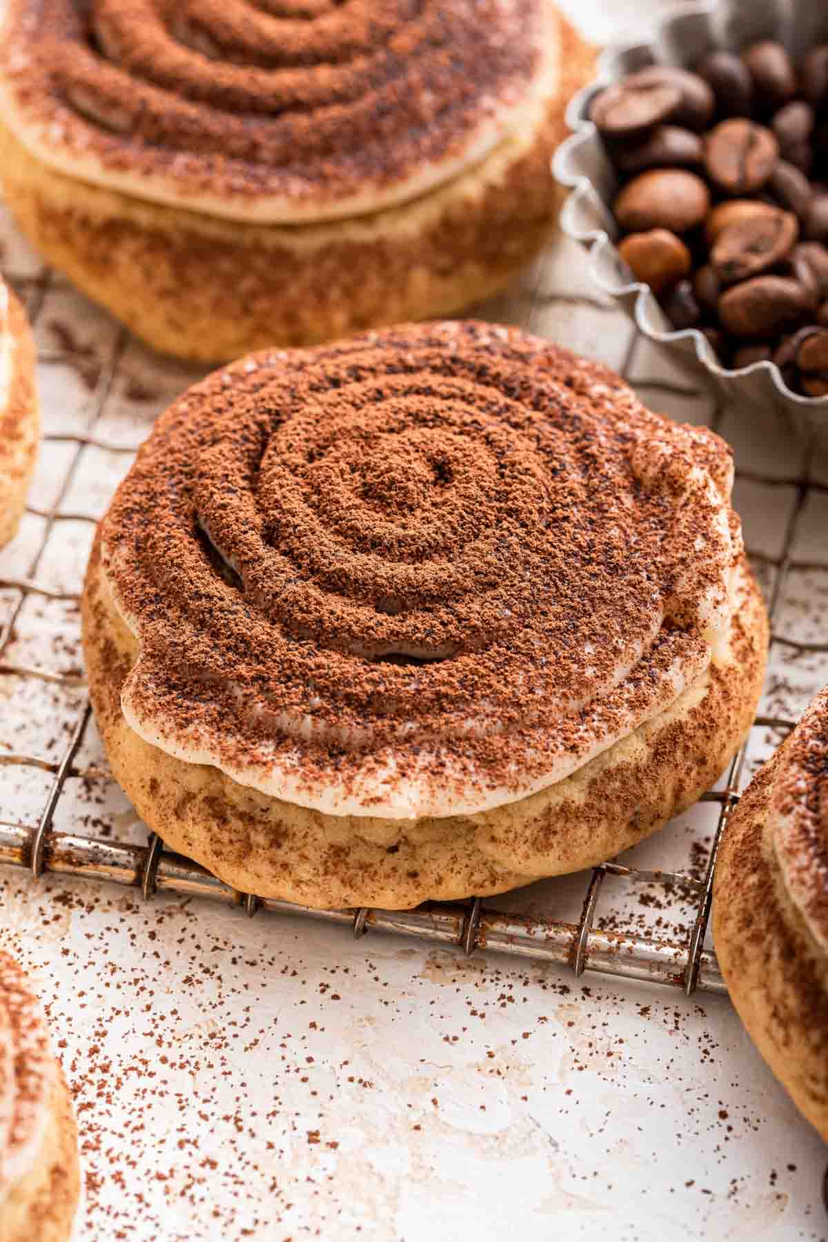 Tiramisu cookie with concentric circle frosting dusted with powdered sugar close-up shot.